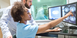 Healthcare workers examining x-ray images